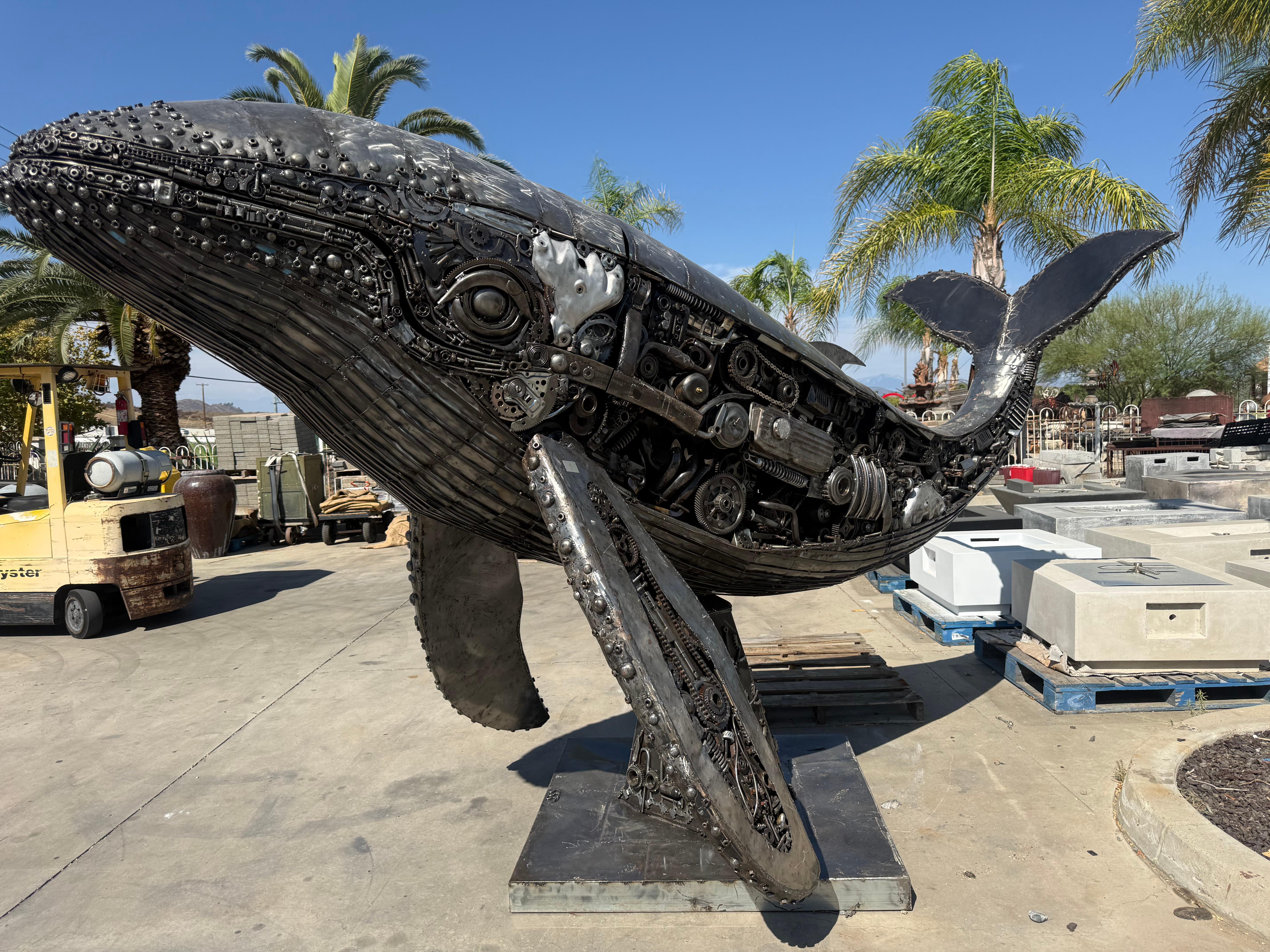 Steel humpback whale built from engine parts in the WaterWise yard
