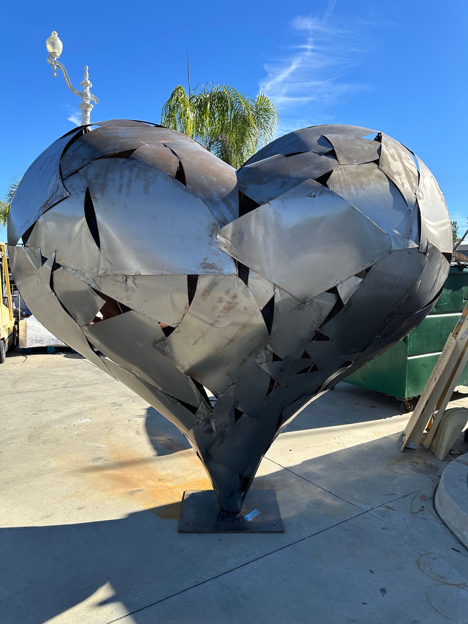Layered metal heart sculpture on a display base