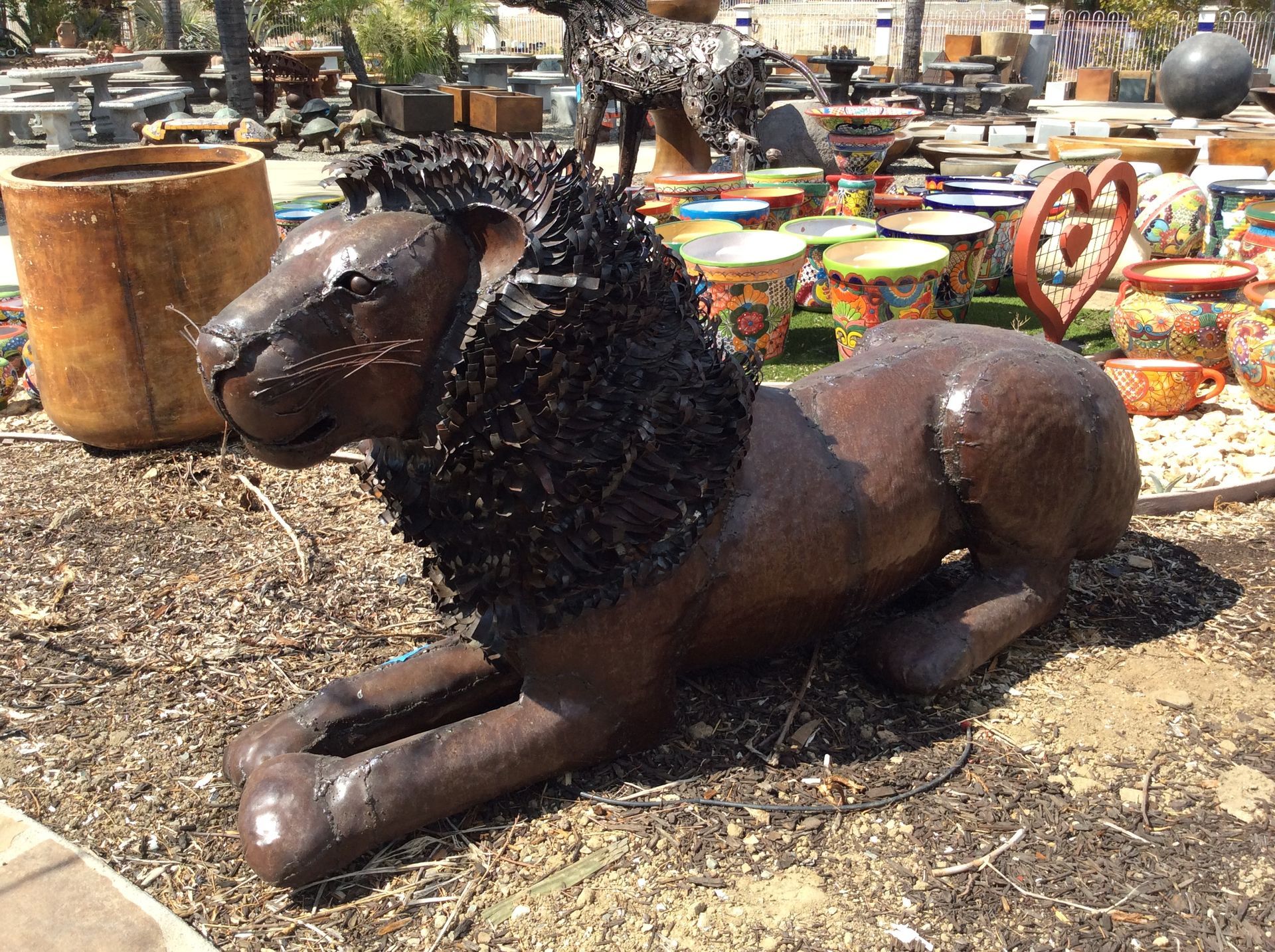Recycled metal lion sculpture at rest